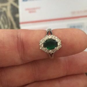 Silver band ring with a green stone